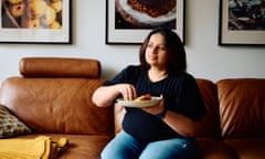 A woman sitting on a couch enjoying a homemade curry with bread