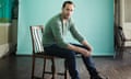 Joseph Fiennes sitting on a chair wearing jumper and jeans