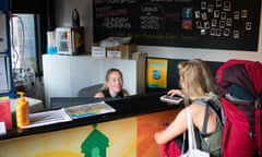 Backpacker checking into reception at hostel in Melbourne