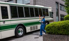 A transport vehicle arrives for the trial of Michael Taylor and his son, Peter, at the Tokyo district court on 14 June.