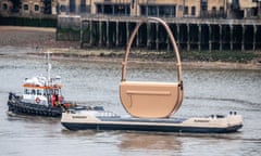 A giant Burberry handbag is towed into London on the River Thames.