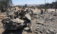A destroyed vehicle sits amid debris in the aftermath of an Israeli airstrike near Lebanon's southern village of Jmaijmeh, on July 19.