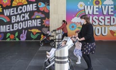 two women with strollers in front of welcome back melbourne signs