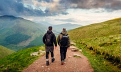 two hiking friends pictured from the rear, walking along a hiking path on Ben Nevis in Scotland