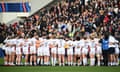 England players form a huddle.