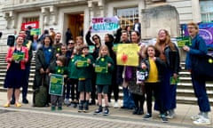 Children and adults hold signs outside of Hackney town hall