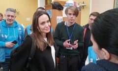 Angelina Jolie listening to volunteers during a visit to Lviv's main railway station.