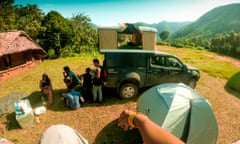 Young people camp next to their campervan among hills in India