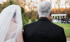 Bride is walked towards an outdoor ceremony