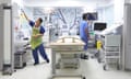 Doctor and Nurse preparing a hospital bed on a private ward in the UK