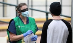 A pop-up clinic begins testing for the coronavirus disease (COVID-19) at Bondi Beach, Sydney<br>A healthcare professional talks to a man at a pop-up clinic testing for the coronavirus disease (COVID-19) at Bondi Beach, after several outbreaks were recorded in the area, in Sydney, Australia April 1, 2020. REUTERS/Loren Elliott