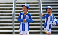 Young Brighton fans play outside the stadium