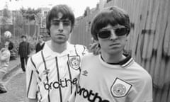 Oasis Soccer Fans<br>*Premium archive - higher fees*
Singer Liam Gallagher and his guitarist brother Noel Gallagher of rock band Oasis, pose in Manchester City football shirts, 9th May 1994. Other band members can be seen in the background (left to right, from 2nd left) bassist Paul McGuigan, drummer Tony McCarroll and rhythm guitarist Paul 'Bonehead' Arthurs. (Photo by Kevin Cummins/Getty Images)