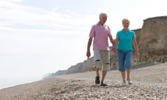 mature couple walking on shingle beach. Image shot 2009. Exact date unknown.<br>BD7PC9 mature couple walking on shingle beach. Image shot 2009. Exact date unknown.