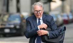 man in a suit clutching a briefcase under his arm