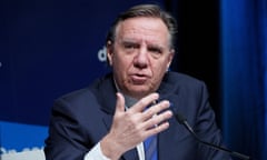 Quebec Premier Francois Legault speaks into a microphone at a news conference