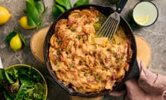 Topview of a cheesy vegetable bake in a pan, with a spatula