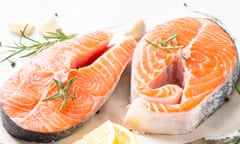 Fresh salmon steaks with herbs on a cutting board