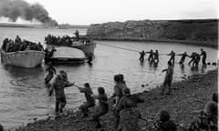 Survivors from HMS Sir Galahad being hauled ashore by colleagues at Bluff Cove, East Falkland, after the ship was hit by an Argentinian air attack.