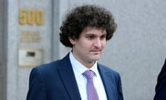 Man wearing blue suit and striped tie in front of a building