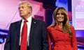 man in a suit and woman in red jacket on a stage