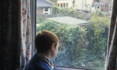 8 year old boy silhouetted against bedroom window