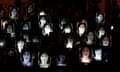 People hold up photos of anti-corruption journalist Daphne Caruana Galizia during a protest marking eighteen months since her assassination, outside the office of Prime Minister Muscat in Valletta