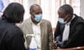 Paul Rusesabagina (centre) consults with his lawyers after his pre-trial court session at the Kicukiro Primary court in Kigali, Rwanda, on September 14, 2020