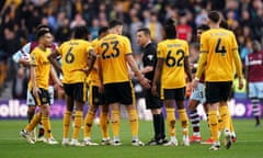 Wolves players surround the referee after Max Kilman’s late equaliser against West Ham is referred to VAR
