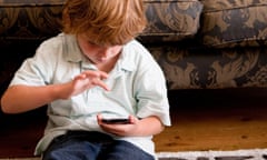 Two boys relaxing at home with a digital tablet and smart phone<br>CBKJKD Two boys relaxing at home with a digital tablet and smart phone