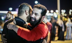 two Arab men embracing joyfully