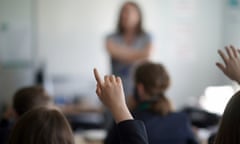 Child raising a hand in class
