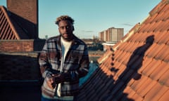 Myles Smith standing next to a tiled roof on a sunny day