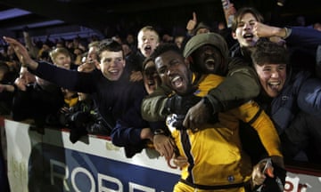Sutton United’s Bradley Hudson-Odoi celebrates with fans after their FA Cup third round replay 3-1 victory at The Cherry Red Records Stadium.