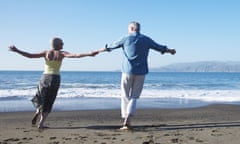 Middle aged couple having fun on the beach