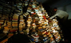 HACHIM<br>Iraqi assistant Imam Sheikh Mahmood Hachim sifts through the thousands of books now stored in a room of the Imam Alhaq Ali mosque, in the Thawra district of Baghdad, Sunday May 25, 2003. The books were reportedly looted from the national library after the fall of the capital, and some were brought back when clerics called for their return. (AP Photo/Saurabh Das)