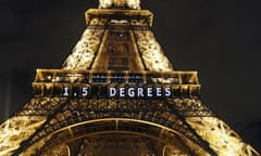 The Eiffel tower is lit up with a reference to the tougher global warming target of 1.5C that is expected to appear in the final draft Paris climate text.