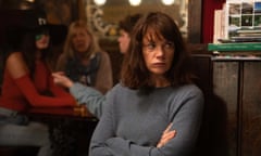 Ruth wilson in a pub with her arms folded, looking hunted/defiant