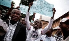Congolese protesters in Kinshasa hold signs calling for the removal of President Joseph Kabila.
