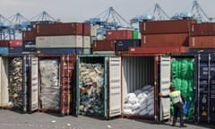 An official inspects waste shipments in Malaysia