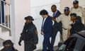 Samuel Bankman-Fried, center, is escorted out of the Magistrate Court building the day after his arrest in Nassau, Bahamas, Tuesday, Dec. 13, 2022. The U.S. government charged&nbsp;Bankman-Fried, the founder and former CEO of&nbsp;cryptocurrency&nbsp;exchange FTX, with a host of financial crimes on Tuesday, alleging he intentionally deceived customers and investors to enrich himself and others, while playing a central role in the company's multibillion-dollar collapse. (Austin Fernander/The Tribune Bahamas via AP)