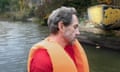 Bertie Carvel in 2023 sitting in a boat on water, wearing an orange lifejacket over a red T-shirt