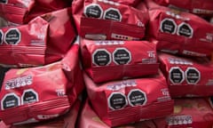 Piles of red paper bags with black hexagons on them.