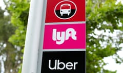 FILE PHOTO: A sign marks a rendezvous location for Lyft and Uber users at San Diego State University in San Diego, California, U.S., May 13, 2020. REUTERS/Mike Blake/File Photo