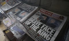 Newspapers reporting on King Charles’s health are seen on a newsstand in London
