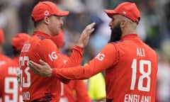 Jos Buttler and Moeen Ali wearing red England kit.