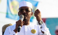 Deby speaks to a crowd on a microphone during an election campaign rally