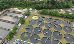 Drone view of treatment works at Mogden, showing 20 circular tanks, each with a large arm that scrapes around the tank