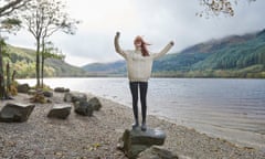 Woman laughing by the side of a loch<br>Posed by model GettyImages-690697543