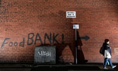 a sign painted on the side of a house in leeds that points the way towards a food bank